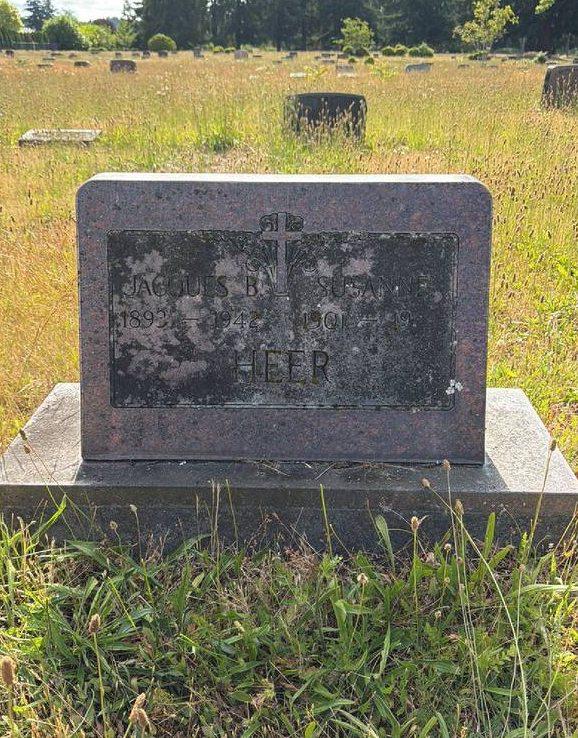 A grave lost in tall, unmown grass before seasonal grounds care